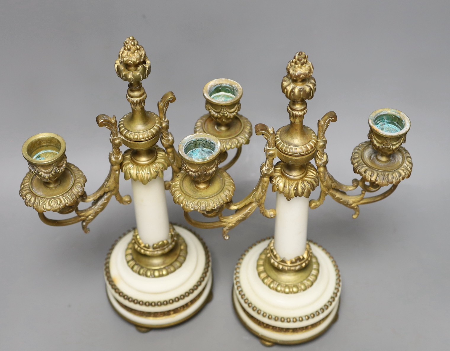 A pair of gilt bronze and marble two branch candelabra, 30cms high